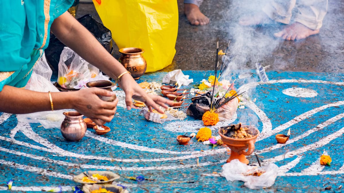 An immersive capture of a Hindu ritual at Ganga Ghat with flowers and sacred elements.